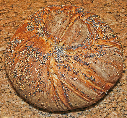 A finished loaf of multigrain bread.