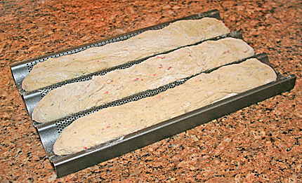 Herb Sweet Pepper Bread dough rising in baguette loaf forms.